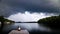 Dark cumulus storm clouds approaching a cottage dock on Lake Joseph, Ontario.