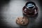 Dark cup of coffee saucer on wooden board cookies