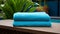 Dark Cyan Stacked Towels By The Pool