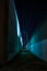 Dark and eerie city alley with tall walls at night