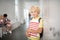 Dark-eyed handsome boy holding notebooks standing near lockers