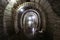 Dark flooded concrete vaulted drainage mine tunnel