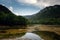 Dark and Foggy lake with hills. after the rain