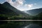 Dark and Foggy lake with hills. after the rain