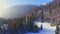 Dark forest of evergreen trees covered with snow-white snow under lush clouds