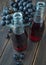 Dark fresh grape juice in glass bottles