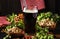 Dark German beer is poured into a glass, fresh green hops and bowls with salty snacks and nuts, autumn beer festival concept, dark