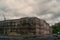 Dark gloomy double-storey house under a cloudy sky