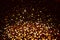Dark golden colored glitter abstract background