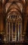 Dark gothic nave and the altar with ornate arches in the Cathedral of the Holy Cross and Saint Eulalia, or Barcelona Cathedral in