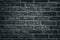Dark gray brick wall close-up texture - rough brickwork background