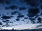 The dark gray clouds enter the blue night sky background.