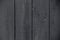 Dark gray painted rustic fence. Dark grey wooden boards texture. Vintage dark gray painted rustic. Old grey wooden board backgroun