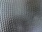 Dark gray perforated metal texture background. Silver steel surface
