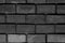 Dark gray sepia background brick symmetrical row rectangular stone with cement seams multichrome base design loft