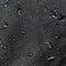 Dark gray waterproof hydrophobic cloth closeup with water drops selective focus background