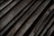 Dark gray wooden charcoal texture, close up.