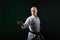 On a dark green background, an active athlete does formal karate exercises