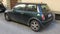 Dark green Mini Cooper car with black roof