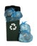 Dark green recycling bin overfilled with garbage bags on white background