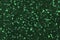 Dark green sparkling background from small foil sequins  closeup