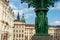 Dark green street lamp with figures in Hradschin in Prague