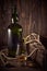 Dark green whisky bottle on a wooden background