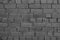 Dark grey brick wall background. Vintage background dark gray brickwall. Dark stone background. Gray concrete texture. Urban dark