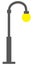 A dark grey gray street light lamp with yellow incandescent bulb white backdrop