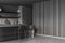 Dark grey kitchen with open shelves and two stools. Corner view