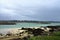 Dark grey sky above the sea with small beach Brittany France Europe