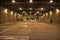 Dark and gritty downtown city street tunnel underpass at night.