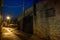 Dark, gritty and wet industrial city alley at night