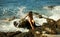 Dark Hair Woman is Sitting on Rocks in Water Rush
