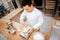 Dark-haired baker adding eggs to dough while cooking croissants