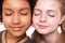 Dark-haired bronzed boy posing with pale long-haired girl