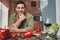 Dark-haired Caucasian male leaning on the countertop