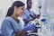 Dark-haired chemist feeling wonderful working in lab