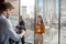 Dark-haired female reporter talking to the videocamera