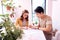 Dark-haired helpful student helping his girlfriend preparing for test