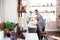 Dark-haired man helping cute daughter washing the dishes