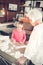 Dark-haired preschool girl studying letters with granny