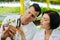 Dark-haired pretty female agriculturist using magnifying glass