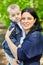 Dark-haired smiling woman holds little boy in