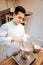 Dark-haired young baker whipping whites of the eggs for pastry