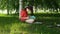 Dark-haired young woman drawing in the park.