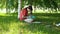 Dark-haired young woman drawing in the park.