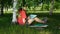 Dark-haired young woman drawing in the park.