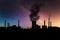 Dark harmful smoke from chimneys of power plant silhouette on night sky with milky way