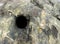 Dark hole drilled in rock